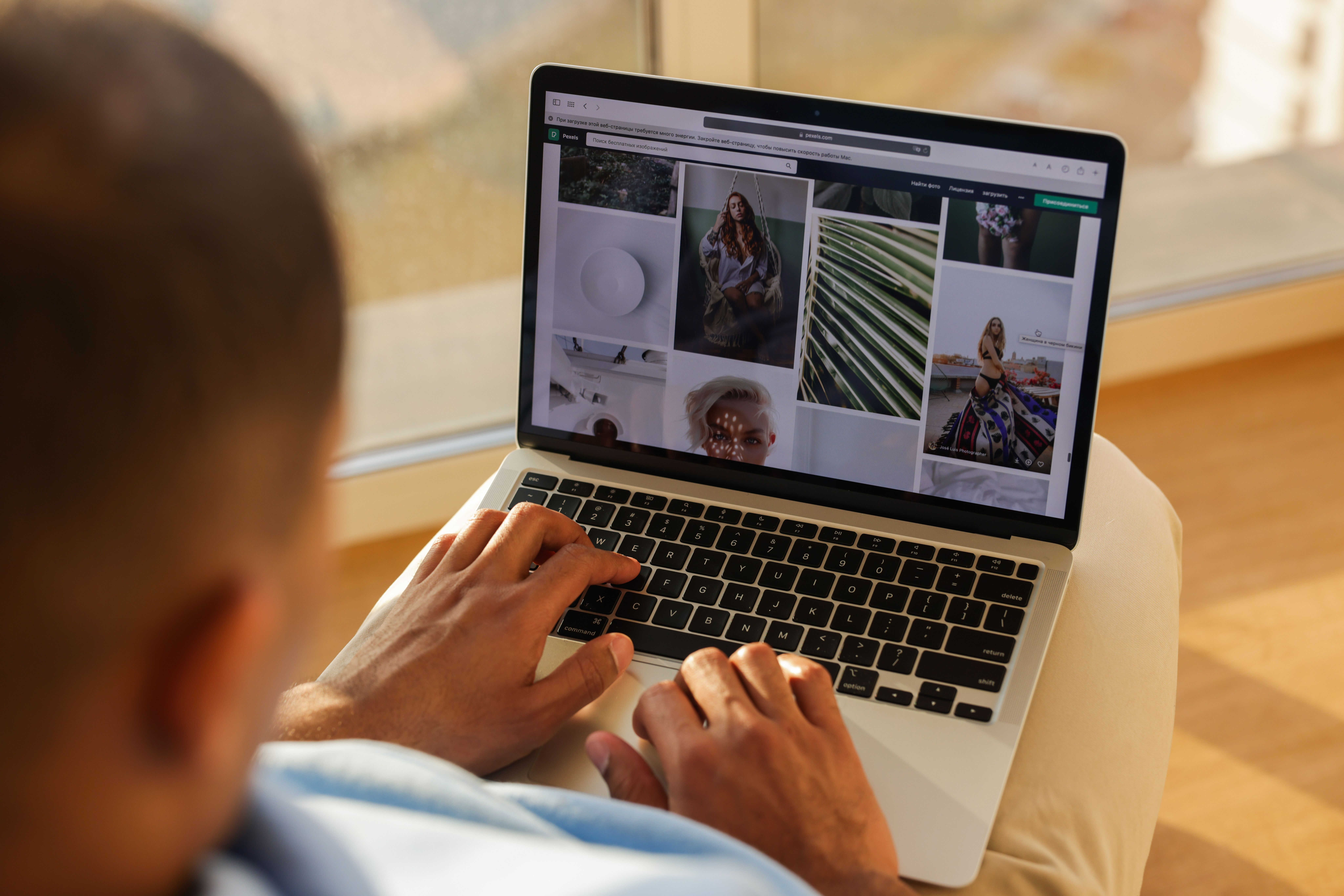 Person using a laptop to browse an online art portfolio website