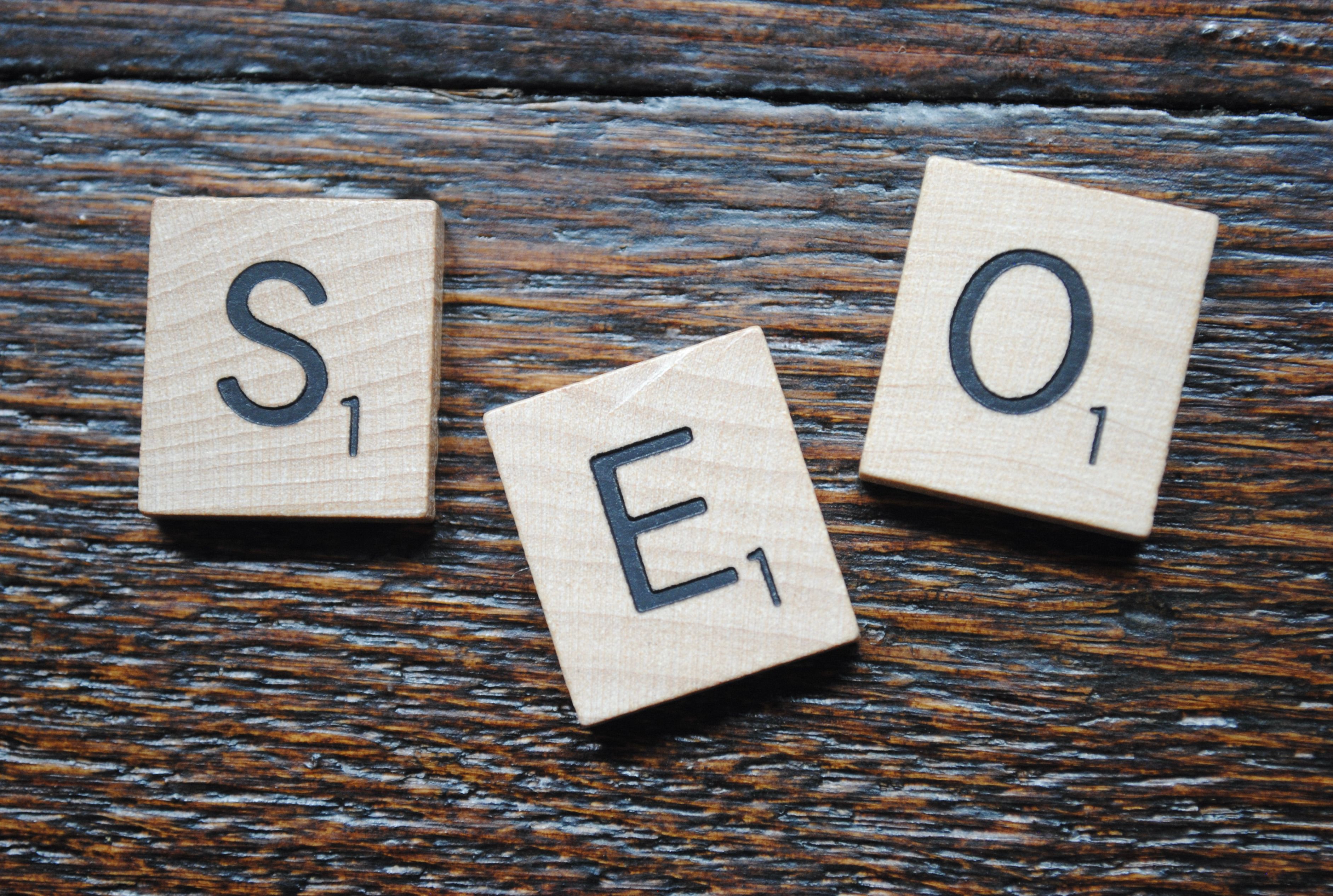 Scrabble tiles spelling SEO on a wooden table for content strategy